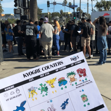 A large group prepares to take on the legendary Pokémon Kyogre on the Santa Monica Pier. The flyer, handed out by a Pokémon Go enthusiast group, lists its weaknesses. Photo: Matt Weinberger/Business Insider