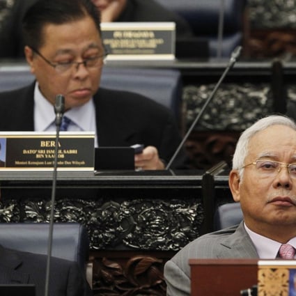 Malaysian Prime Minister Najib Razak, front right, sits next to his deputy, Ahmad Zahid Hamidi, at Parliament House in Kuala Lumpur on March 28. Critics say new voting maps, ratified on the day, will worsen inequality among the constituencies and etch them based on racial lines. Photo: AP