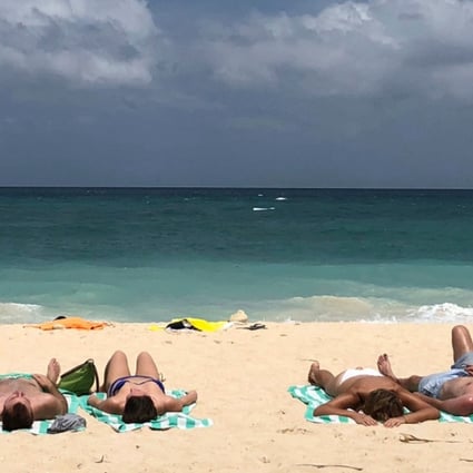 Tourists sunbathe on a beach on Boracay in the Philippines, in March 2018. Picture: AP