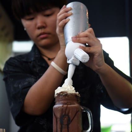 A barista prepares a chocolate milkshake called ‘Death’ at the Kid Mai Death Cafe. Photo: AFP