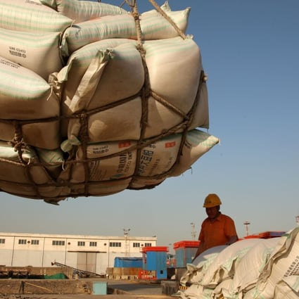 Workers transport imported soybean products at a port in Nantong, China. Photo: Reuters