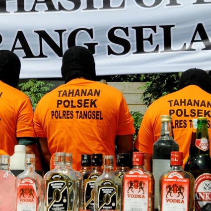 Suspects arrested for producing and selling illegal home-made alcohol are put on parade by Indonesian police during a public display in South Tangerang, outside Jakarta. Photo: AFP