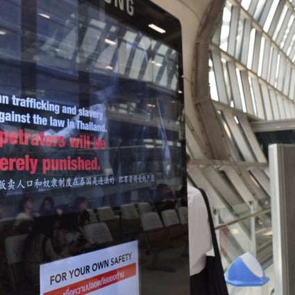 A television screen showing a message warning against human trafficking at Bangkok's main Suvarnabhumi Airport. Photo: Thomson Reuters Foundation