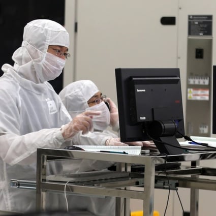 Chinese employees dressed in dust-proof clothing work at a plant of Semiconductor Manufacturing International Corp in Beijing. China’s chip industry has become closer to the world’s first-tier as domestic-made chips are now being used in many industries, according to Diao Shijing, the director of information technology at the Ministry of Industry and Information Technology. Photo: Handout