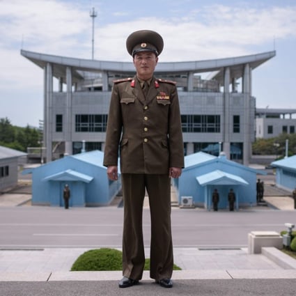 In a photo taken on June 2, 2017, North Korean soldier Lieutenant Kim poses for a portrait before the military demarcation line at the truce village of Panmunjom within the Demilitarized Zone (DMZ) separating North and South Korea. Photo: AFP