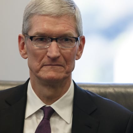 Apple CEO Tim Cook listens as President-elect Donald Trump speaks during a meeting with technology industry leaders at Trump Tower in New York. Photo: AP/Evan Vucci