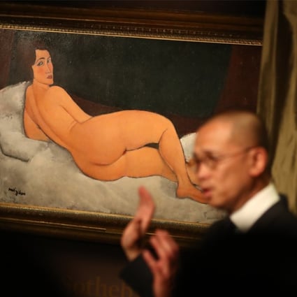 Chief executive of Sotheby’s Hong Kong Kevin Ching unveils Nu Couche (sur le côté gauche), a 1917 painting by 20th-century Italian painter Amedeo Modigliani, ahead of its auction in New York on May 14. Photo: Nora Tam