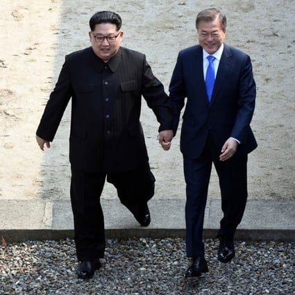 North Korean leader Kim Jong-un (left) and South Korean President Moon Jae-in cross the military demarcation line at the border village of Panmunjom. Photo: AP