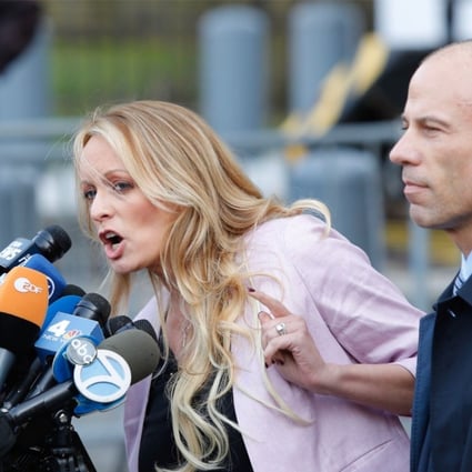 Adult film star Stormy Daniels, whose real name is Stephanie Clifford, speaks outside US federal court in New York with her lawyer Michael Avenatti on April 16. She filed a defamation suit against US President Donald Trump on Monday. Photo: AFP
