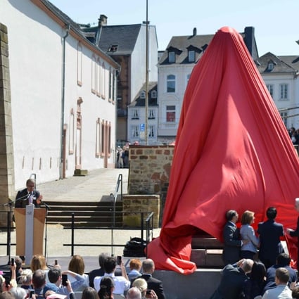Visitors look on as a statue of German revolutionary thinker Karl Marx is unveiled. Photo: AFP