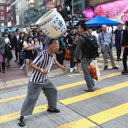 A stretch in popular Mong Kok is famous for street performers, but the fight for space has resulted in congested streets. Photo: Edward Wong