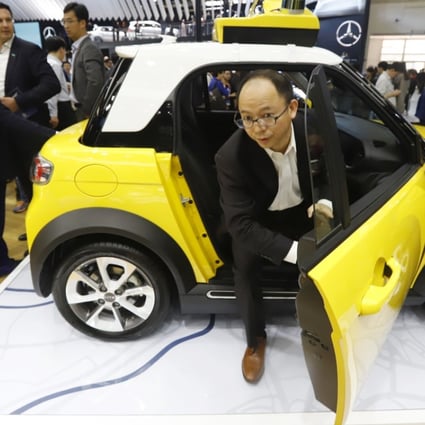 An attendee gets off from an autonomous electric car from BAIC during the China Auto 2018 show in Beijing in April this year. In the same month, China issued draft guidelines on road testing autonomous vehicles and is reviewing a final version. The technology behind self-driving cars is considered critical to the government’s plan to elevate the nation’s standing in the global auto industry. Photo: AP