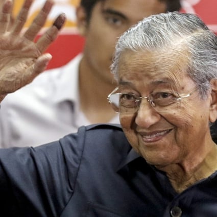 Malaysian Prime Minister Mahathir Mohamad waves at the end of a press conference in Kuala Lumpur. Photo: EPA