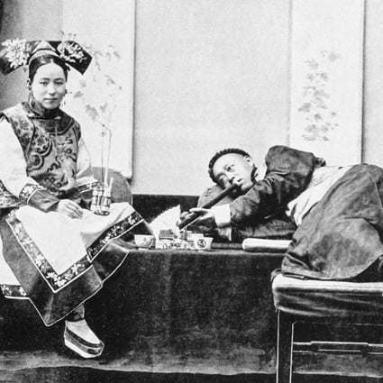 A man smokes opium in Peking, with an attendant holding a tobacco pipe, circa 1905. Picture: Alamy