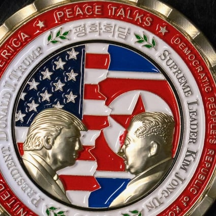 The coin depicts Trump and Kim, described as North Korea's ‘Supreme Leader’, in profile facing each other in front of a background of US and North Korean flags. PhotoL AFP