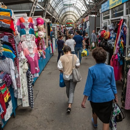 Shoppers walk past stalls near the Green Bazaar in Almaty, Kazakhstan, in April. An agreement between China and the Eurasian Economic Union will give Chinese companies an edge over their EU competitors in Central Asia. Photo: Bloomberg