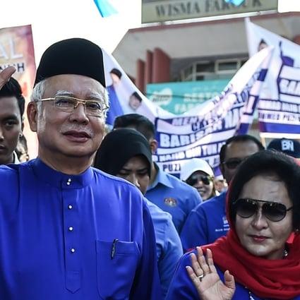 Najib Razak and his wife Rosmah Mansor waving as they arrive at a nomination centre to hand over election documents in Pekan, Malaysia. Photo: AFP