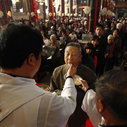A man receives Holy Communion during an Easter Sunday mass at the state-controlled Xishiku church in Beijing. The detained Japanese may have been targeted in a crackdown on missionary work. Photo: Reuters