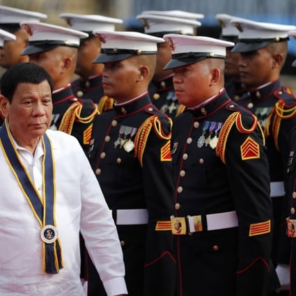 Filipino President Rodrigo Duterte reviews honour guards during the 120th Philippine navy anniversary celebration in Manila, Philippines, on Wednesday. Photo: EPA-EFE