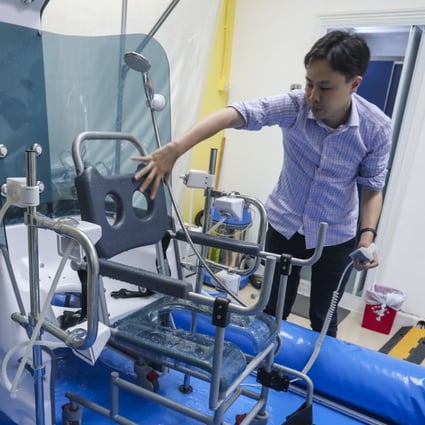 Inventor Samuel Hui Sing-kwong with his automated bathing device in Kwai Chung. Photo: Jonathan Wong
