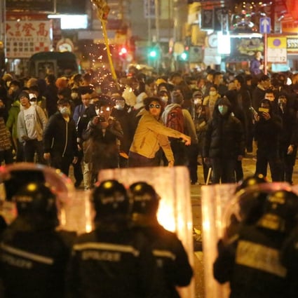 Police confront protesters in Mong Kok during clashes over illegal food stalls during the three-day Lunar New Year holiday in 2016. Photo: Edward Wong