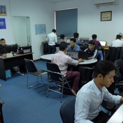Fresh News staff work in their newsroom in Phnom Penh. Photo: AFP