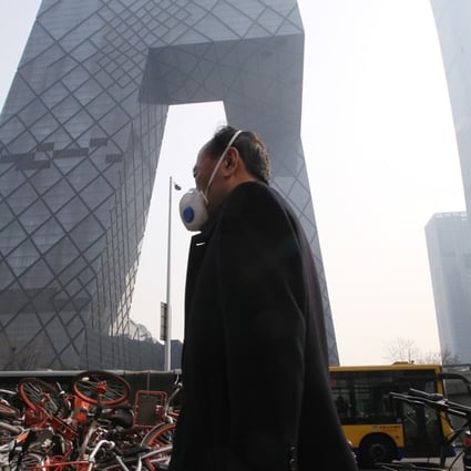 A man wears a face mask in downtown Beijing on an overcast day in March. Levels of ozone are forecast to spike in the city and the surrounding area over the coming week. Photo: Simon Song