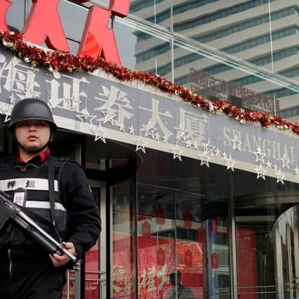 A security guard walks out of the Shanghai Stock Exchange building at the Pudong financial district in Shanghai, China. Photo: Reuters