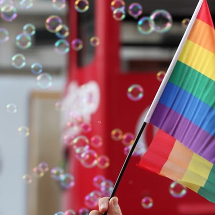 A flag is held aloft during Hong Kong Pride Parade in 2012. Hong Kong does not recognise same-sex marriages, but a number of court cases in recent years have put the spotlight on the issue. Photo: Nora Tam