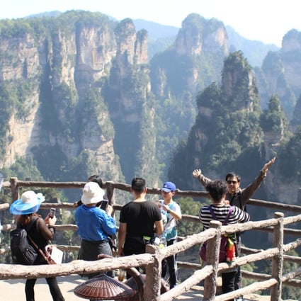 Tourists on Yuanjiajie viewing platforms in Zhangjiajie National Forest Park. Photo: Ed Gerstner
