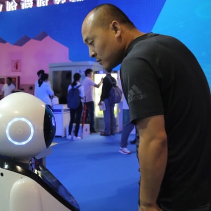 A Chinese visitor watches a robot on show at the 21st China Beijing international high-tech expo in Beijing, China, 2018. Photo: EPA-EFE