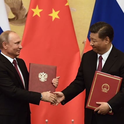 Russian President Vladimir Putin and his Chinese counterpart Xi Jinping shake hands during a signing ceremony in Beijing on Friday. Photo: AFP