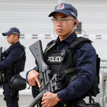 Singaporean policemen stand guard at a media centre for the summit. Photo: Reuters