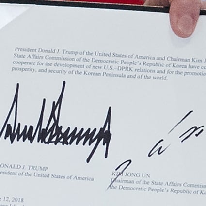 The signatures of US President Donald Trump (L) and North Korea's leader Kim Jong-un seen on the joint statement during Tuesday’s summit in Singapore. Photo: AFP