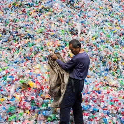 A Chinese labourer sorts plastic bottles for recycling in a village on the outskirts of Beijing, in September 2015. For years the world’s top destination for recyclables, China banned 24 types of solid waste imports from January 2018. Photo: AFP