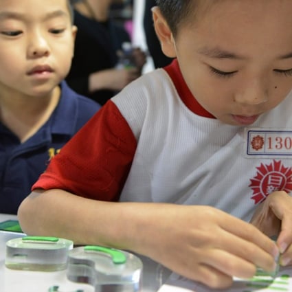 A boy stamps a Chinese character during an exhibition in Taipei. Taiwan, Macau and Hong Kong are the few places where traditional characters are widely used when writing Chinese. Photo: AFP