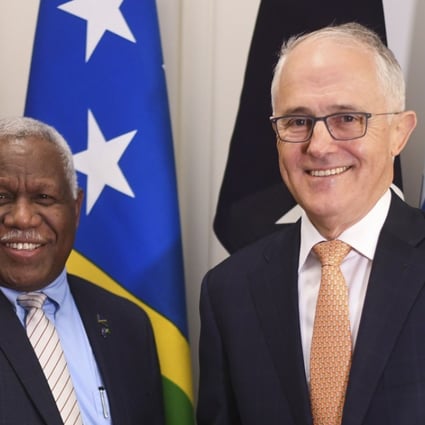 Prime Minister of the Solomon Islands Rick Houenipwela and Australian Prime Minister Malcolm Turnbull shake hands ahead of a bilateral meeting in Canberra. Australia has stepped in to majority fund an undersea high-speed communications cable to the Solomon Islands. Photo: AFP