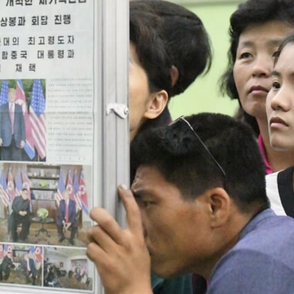 People at a subway station in Pyongyang read a newspaper report about the meeting between North Korean leader Kim Jong-un and US President Donald Trump. Photo: AP