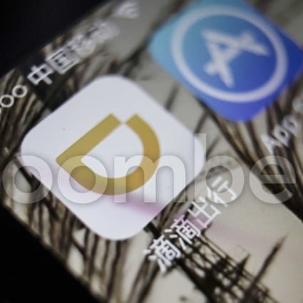 The icon for Didi Chuxing application, left, is displayed on a smartphone screen in this arranged photograph taken in Shanghai, China, on Sunday, May 22, 2016. Photographer: Qilai Shen/Bloomberg