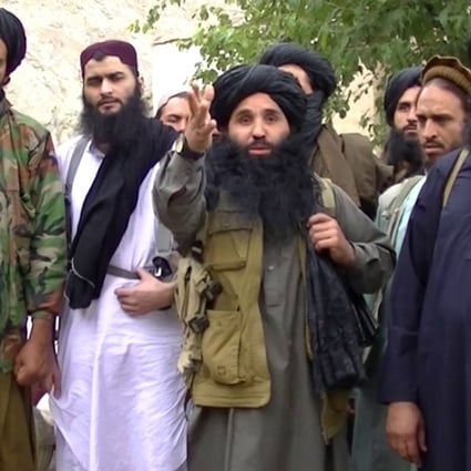 File photo of Mullah Fazlullah (centre) and members of his TTP militant group. Photo: EPA