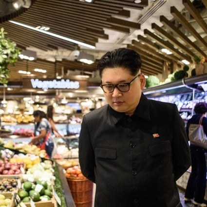 Kim Jong-un impersonator Howard X in a supermarket in Hong Kong. Photo: Anthony Wallace