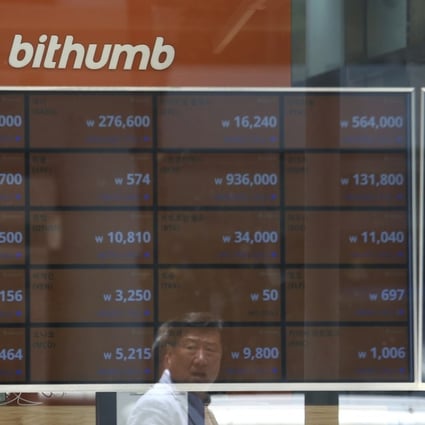 A man is reflected on a screen showing the prices of bitcoin at Bithumb cryptocurrency exchange in Seoul on Wednesday. Bithumb, South Korea's second-largest exchange, said US$31 million worth of virtual currencies have been stolen by hackers, the latest in a series of recent hacks targeting digital currencies. Photo: AP