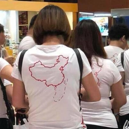 A photo of Chinese tourists wearing T-shirts bearing Beijing’s controversial “nine-dash line” at Vietnam’s Cam Ranh International Airport in May went viral, sparking anger and calls for a China-specific code of conduct. Picture: Twitter / Nga Pham