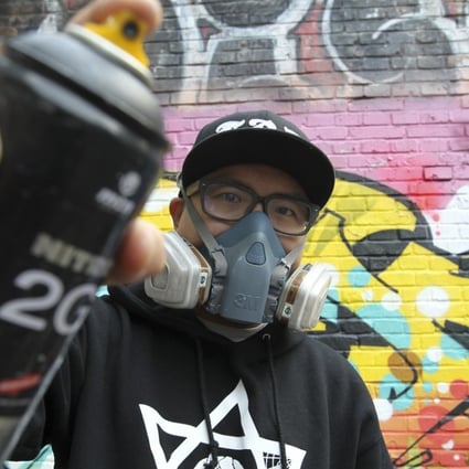 Beijing graffiti artist Andy Chen from the ABS crew in front of one of his designs. Photo: Simon Song