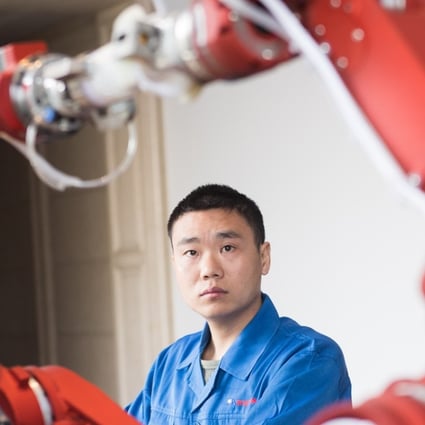 A technician from Rui'an Hsoar Group debugs a robot in Rui'an City in China's Zhejiang province. China has set ambitious technological targets as part of its “Made in China 2025” campaign, but this has led to allegations of unfair competition at home, theft of intellectual property and strong-arming foreign companies in China into sharing knowledge with Chinese entities. Photo: Xinhua