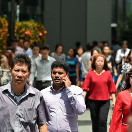 Workers in Singapore’s financial district. Photo: AFP
