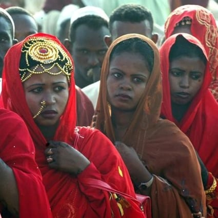 Sudanese women line up during a wedding ceremony in 2006. Photo: Retuers