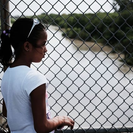 Yerlin Yessehia, 11, of Honduras waits with her family along the border bridge near Brownsville, Texas, on Monday after being denied entry into the US from Mexico. Photo: Getty Images/AFP