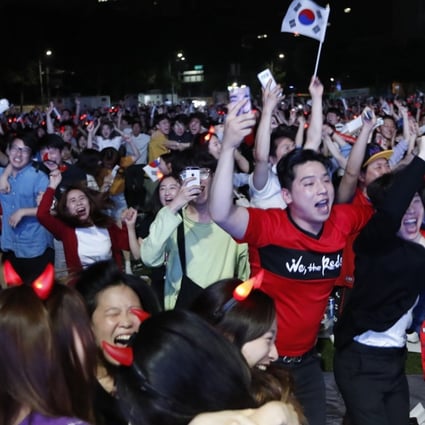 South Korea fans celebrate in front of the Seoul city hall, watching their team beating Germany in the World Cup. Photo: EPA