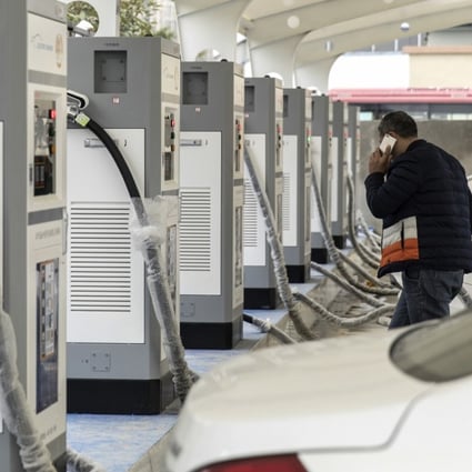 Electric taxis stand at a charging station operated by an electric vehicle showroom in Ningde in Fujian Province on Monday, January 29, 2018. China surpassed the US in 2015 to become the world's biggest market for electric cars. Sales of new-energy vehicles - including battery-powered, plug-in hybrid and fuel-cell vehicles - reached 777,000 units last year and could surpass 1 million this year, the China Association of Automobile Manufacturers estimated. Photo: Qilai Shen/Bloomberg